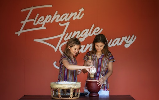 Two people preparing food at Elephant Jungle Sanctuary Samui.