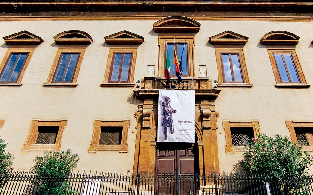 Facade of Antonino Salinas Archaeological Museum in Palermo with entrance banner.