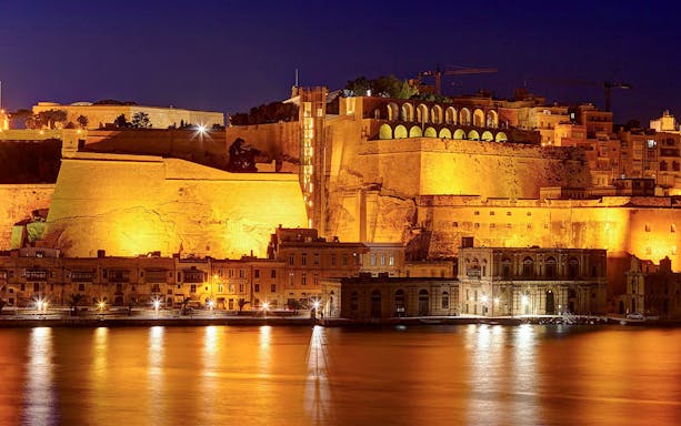 Valletta cityscape illuminated at night during a 3-hour guided tour in Malta.