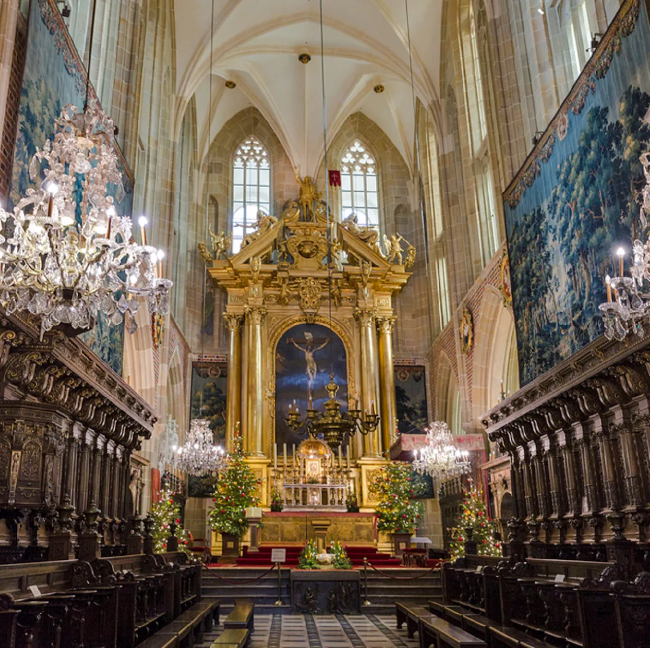 Krakow cathedral interior with ornate altar and chandeliers, part of Old Town tour.