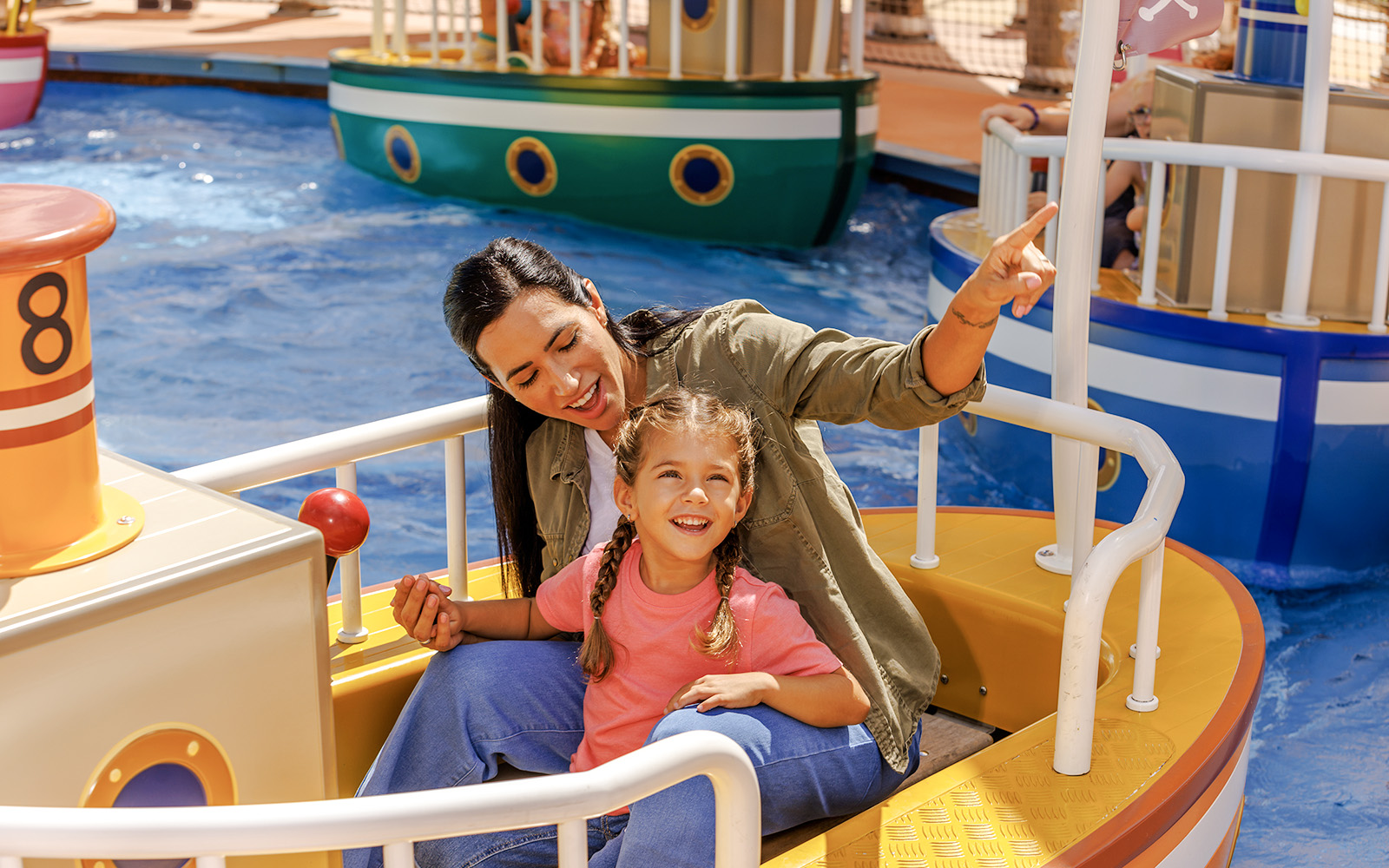 Mother and daughter enjoying a boat ride at Peppa Pig Theme Park, Florida.