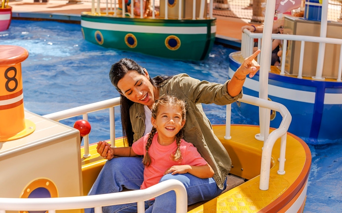 Mother and daughter enjoying a boat ride at Peppa Pig Theme Park, Florida.