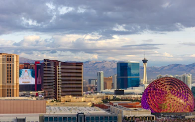 Las Vegas skyline with Stratosphere Tower and colorful dome structure.