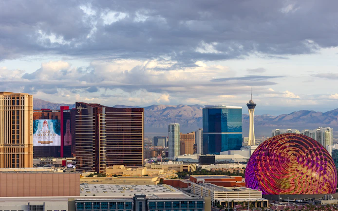 Las Vegas skyline with Stratosphere Tower and colorful dome structure.