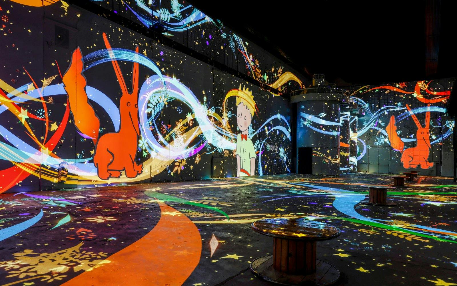 Inside Phoenix des Lumières art center with colorful digital projections.