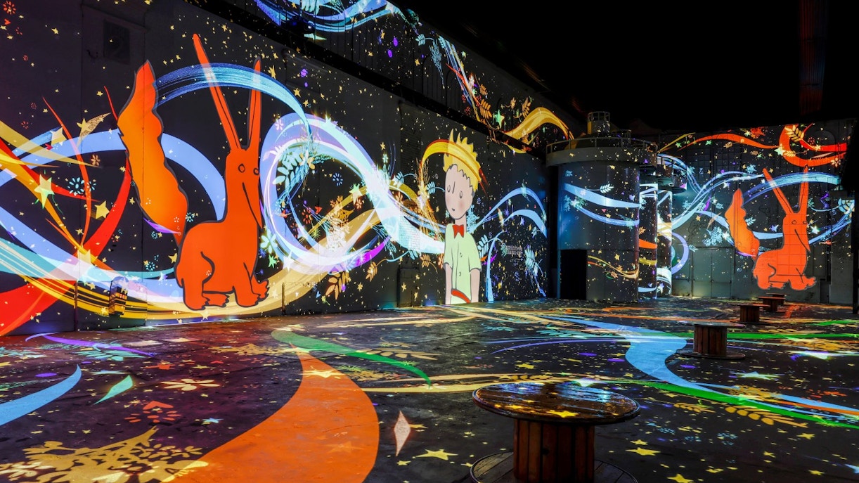 Inside Phoenix des Lumières art center with colorful digital projections.