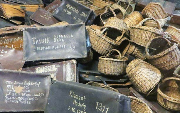 Suitcases and baskets from Auschwitz-Birkenau museum exhibit on guided tour from Warsaw.