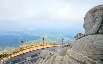 View from Black Virgin Mountain overlooking landscape, featuring large stone statue, Ho Chi Minh City tour.