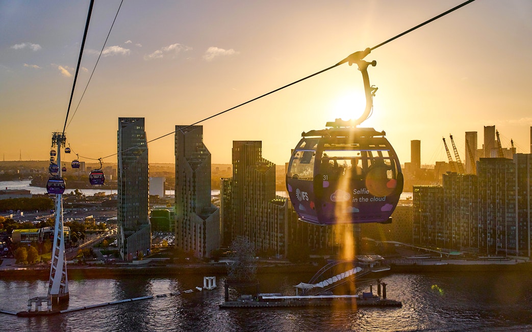IFS Cloud Cable Car over London skyline at sundown.