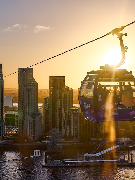 IFS Cloud Cable Car over London skyline at sundown.