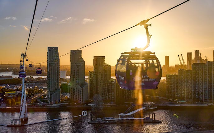 IFS Cloud Cable Car over London skyline at sundown.