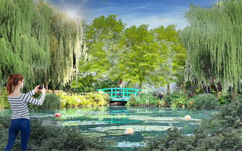 Visitor photographing lush greenery and pond at Gardens by the Bay, Singapore.