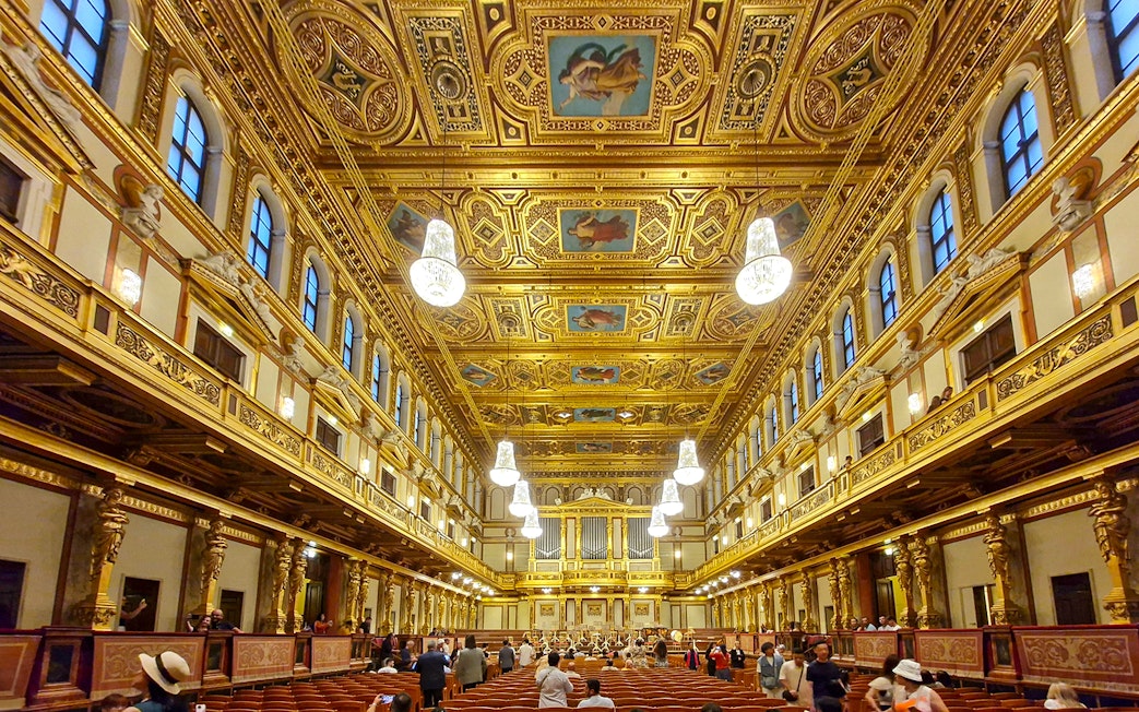 Visitors inside the ornate Golden Hall of Musikverein, Vienna.