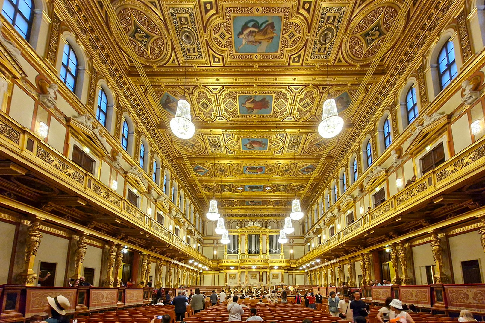 Visitors inside the ornate Golden Hall of Musikverein, Vienna.
