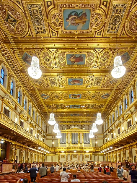 Visitors inside the ornate Golden Hall of Musikverein, Vienna.
