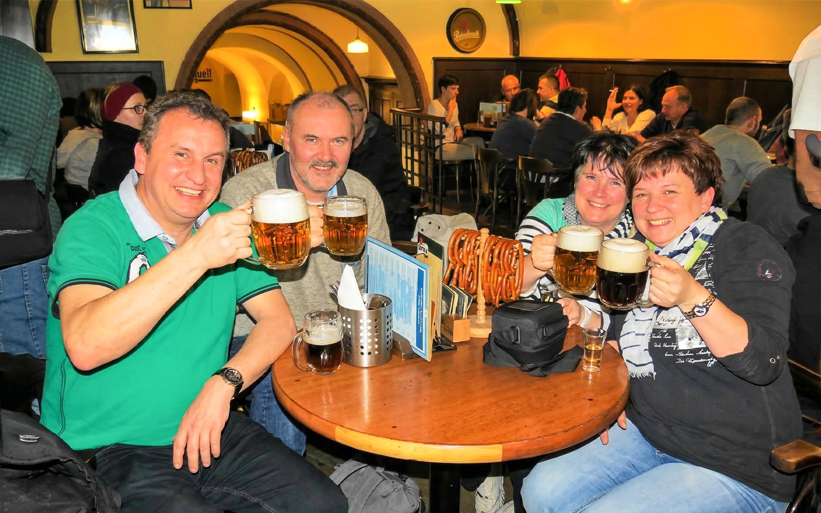 Group enjoying beer at a traditional pub in Prague during the Legendary Beer Tour.