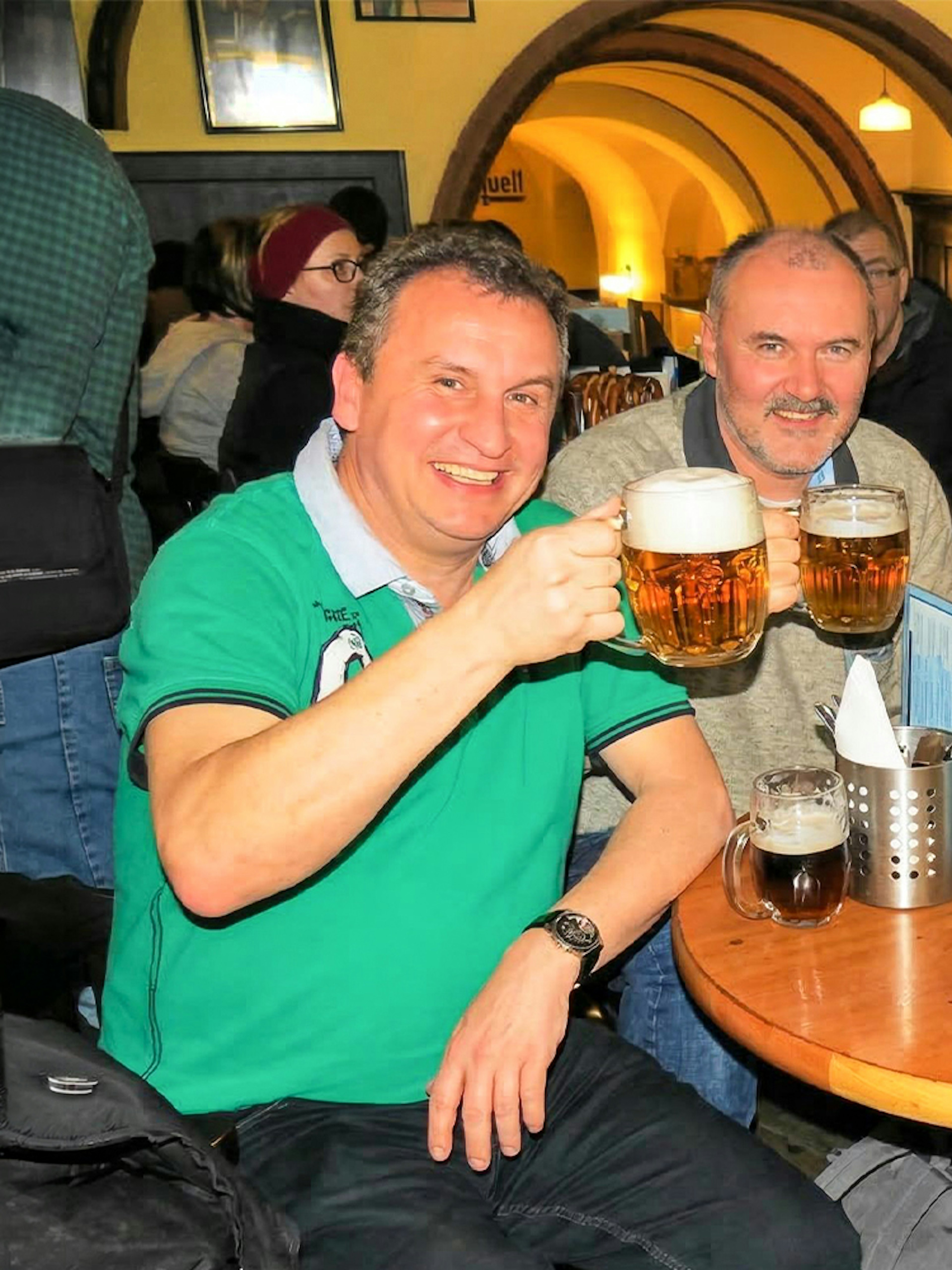 Group enjoying beer at a traditional pub in Prague during the Legendary Beer Tour.