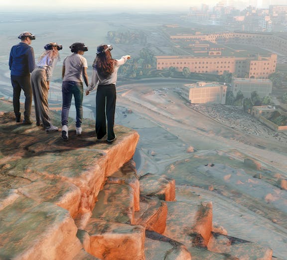 Tourists exploring a historic street with yellow buildings in a European city.