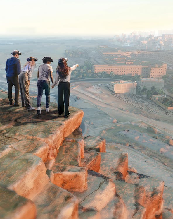 Tourists exploring a historic street with yellow buildings in a European city.