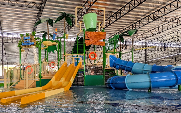 Water park with slides and splash zone, featuring "Lost in the Amazon" theme.