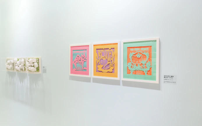 Hello Kitty Island exhibition featuring framed artwork of fairy tales.