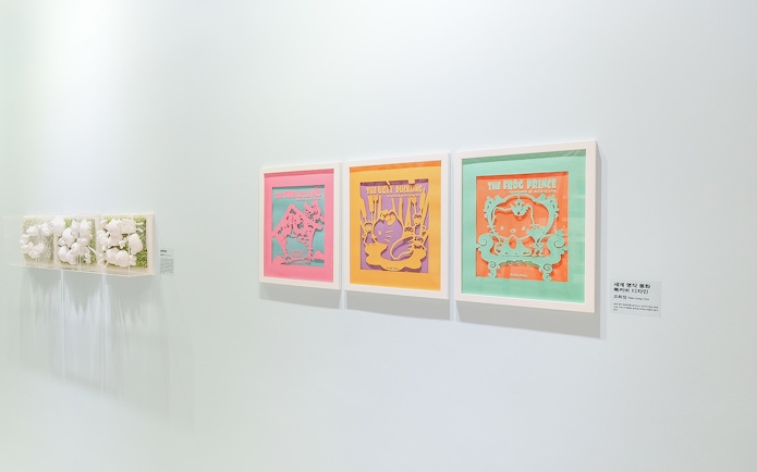 Hello Kitty Island exhibition featuring framed artwork of fairy tales.