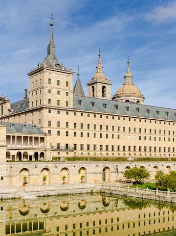 El Escorial monastery with reflection in pond, San Lorenzo de El Escorial, Spain.