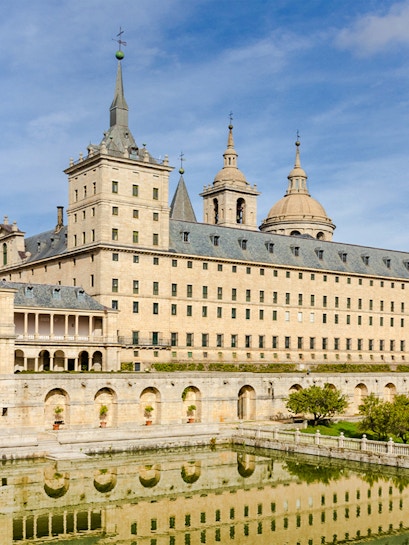 El Escorial monastery with reflection in pond, San Lorenzo de El Escorial, Spain.