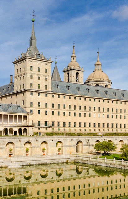El Escorial monastery with reflection in pond, San Lorenzo de El Escorial, Spain.