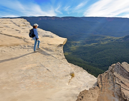 Woman gazing over Grose Valley from Blue Mountains viewpoint in Australia.