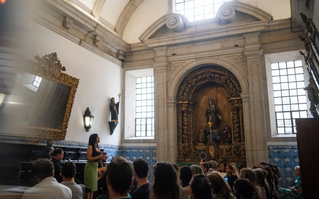 Fado performance at Monastery of São Bento da Vitória, Porto, with audience seated.