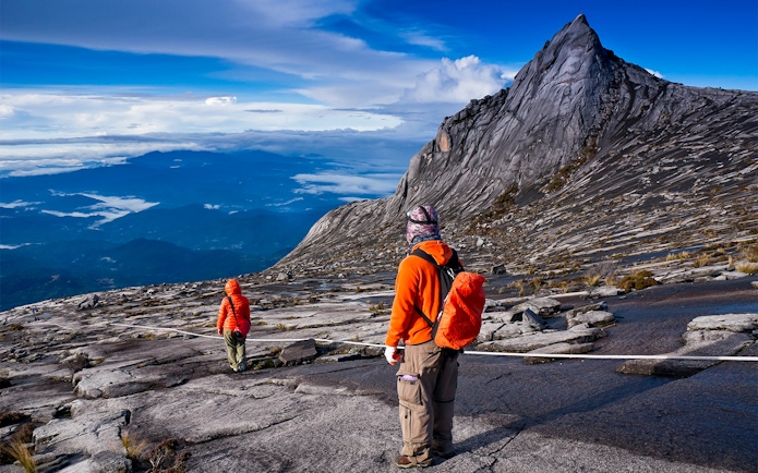 Hikers ascending rocky path on Mount Kinabalu Summit Tour, Malaysia.
