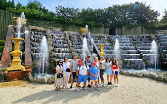 Group in front of Versailles fountain during golf cart and bike tour.
