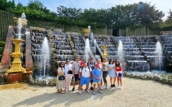 Group in front of Versailles fountain during golf cart and bike tour.