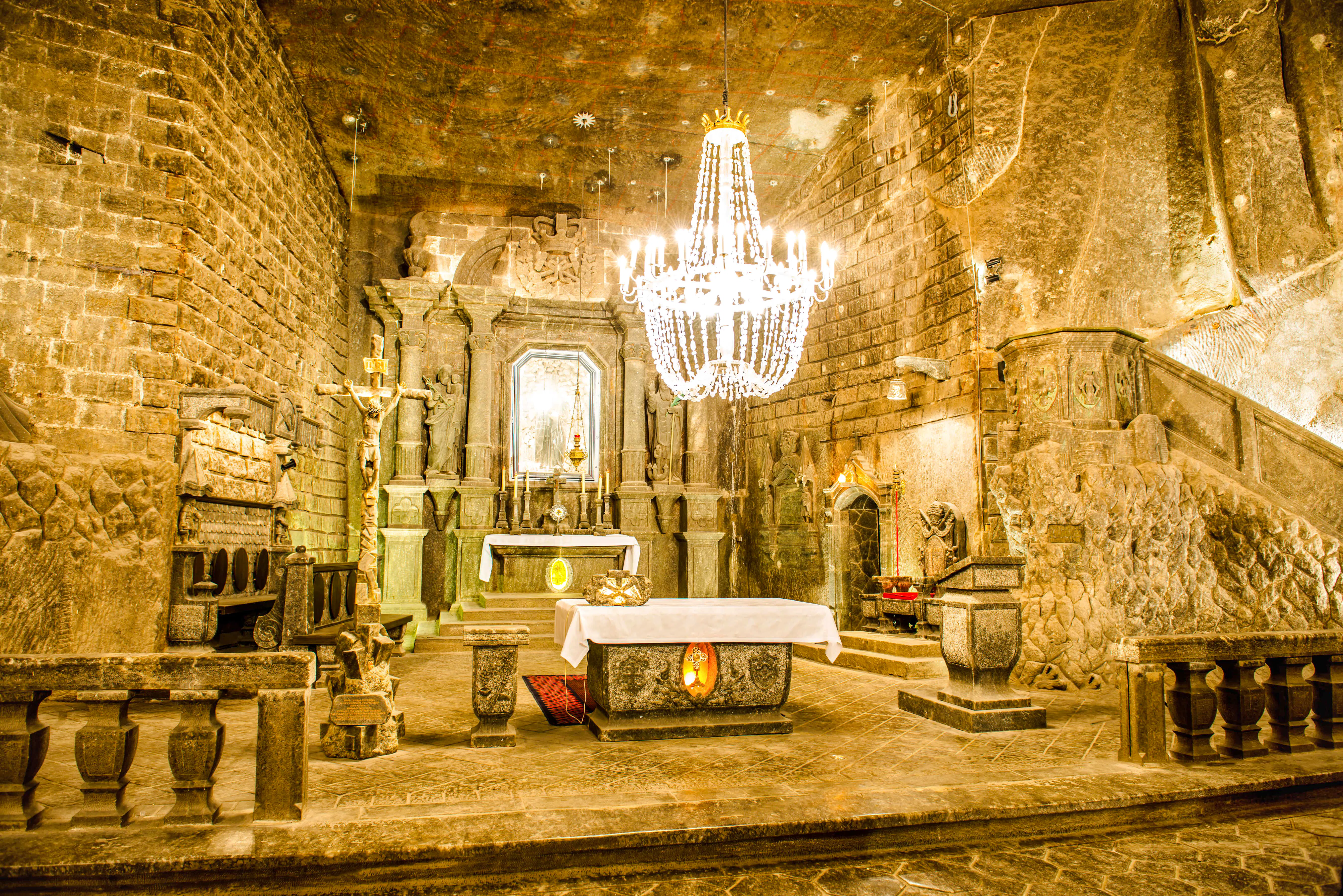 Wieliczka Salt Mine chapel interior with altar and chandelier, Krakow tour.