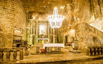 Wieliczka Salt Mine chapel interior with altar and chandelier, Krakow tour.