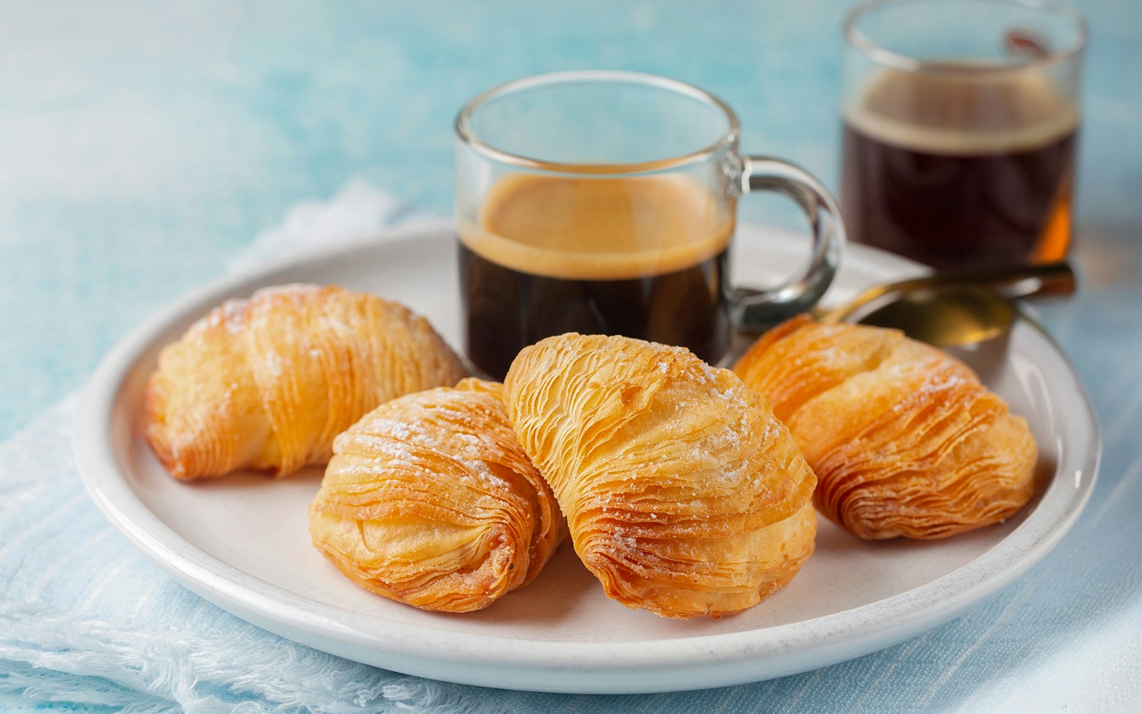 Espresso and sfogliatella on a white plate in a Naples café.