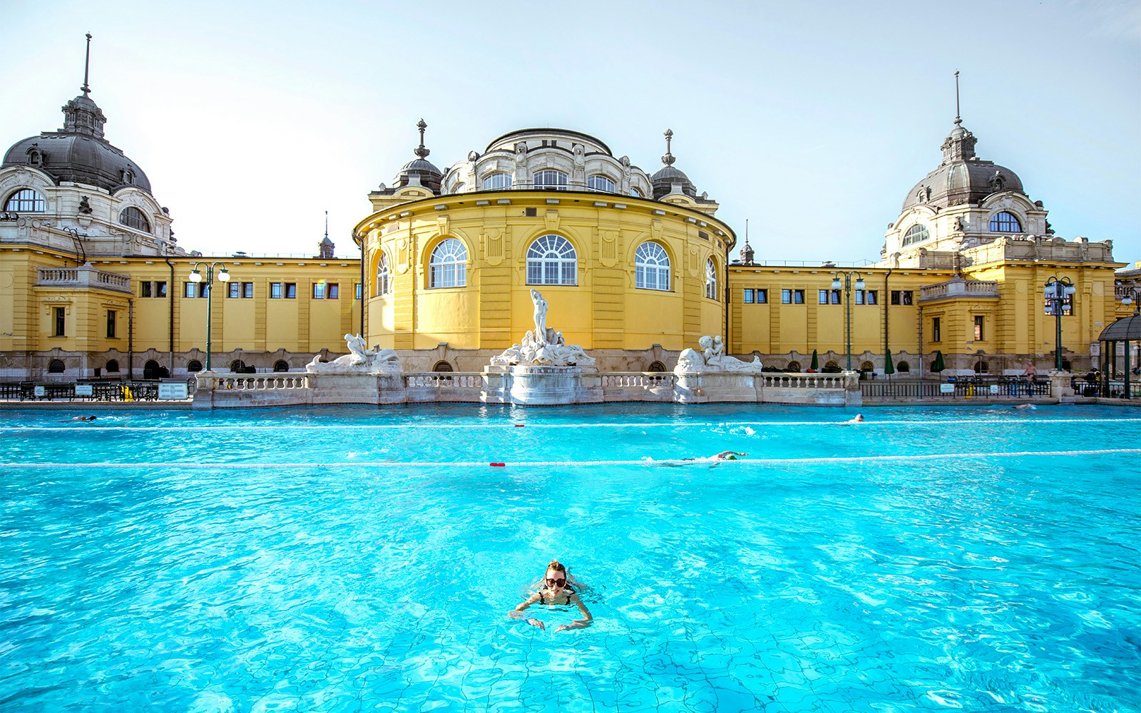 Thermal pools at Budapest Baths with people relaxing and enjoying the historic architecture.