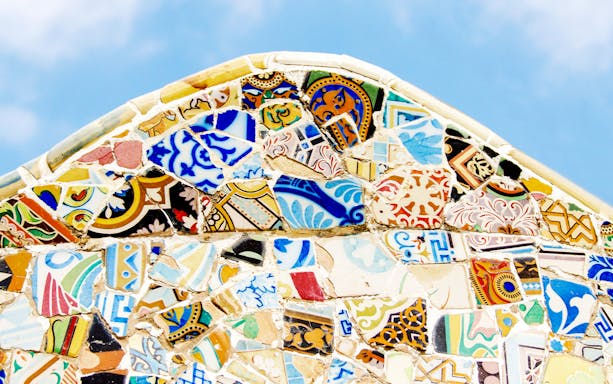 Colorful mosaic tiles with intricate patterns under a blue sky near Betwa River, Jhansi.