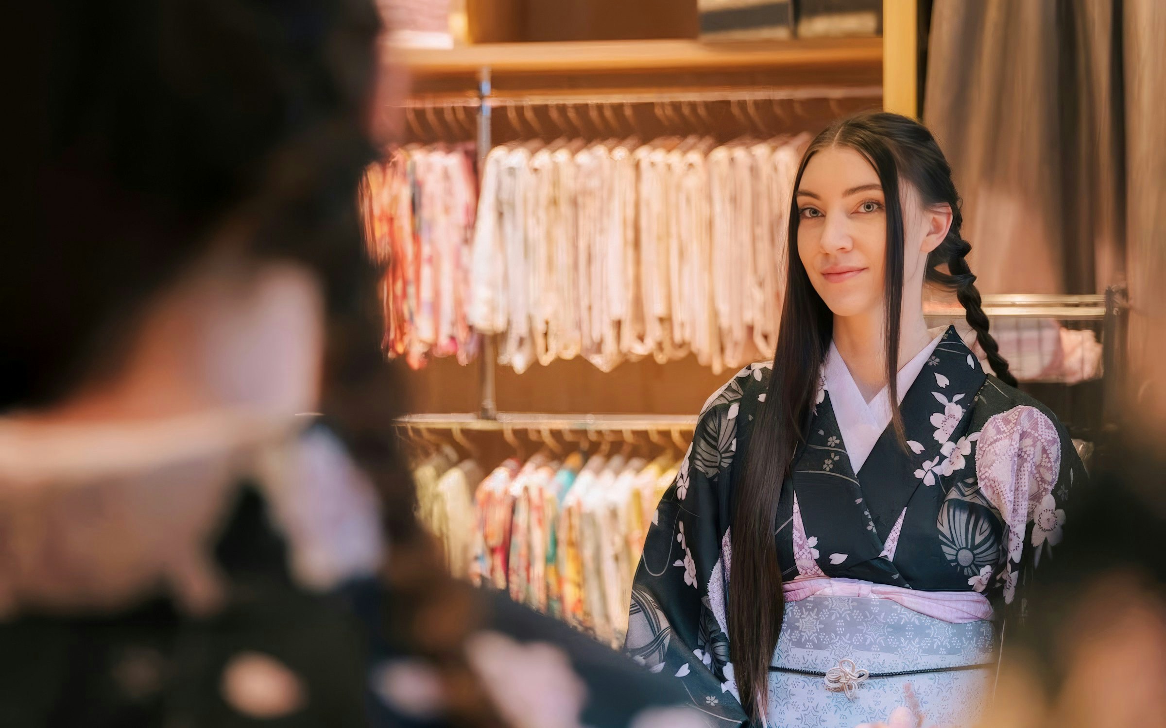 Tourist in kimono getting hair styled at rental service in Japan.