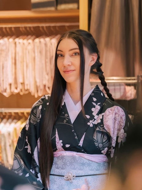 Tourist in kimono getting hair styled at rental service in Japan.