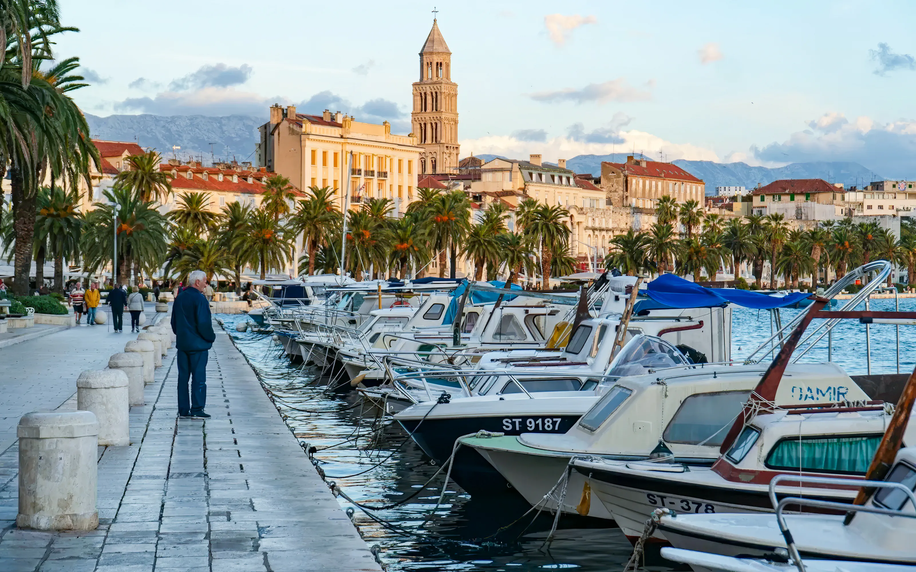 Split waterfront promenade with boats and Diocletian's Palace in the background.