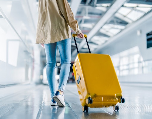 Woman with her luggage at the airport