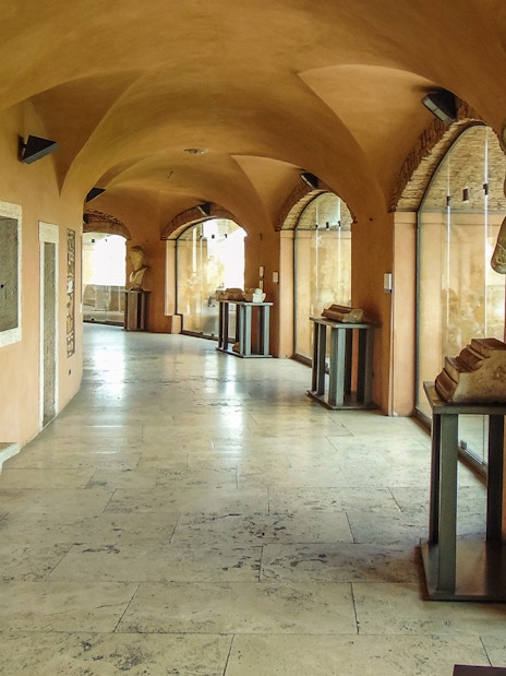Busts and artifacts in a corridor at Castel Sant'Angelo museum, Rome.