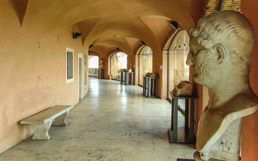 Busts and artifacts in a corridor at Castel Sant'Angelo museum, Rome.