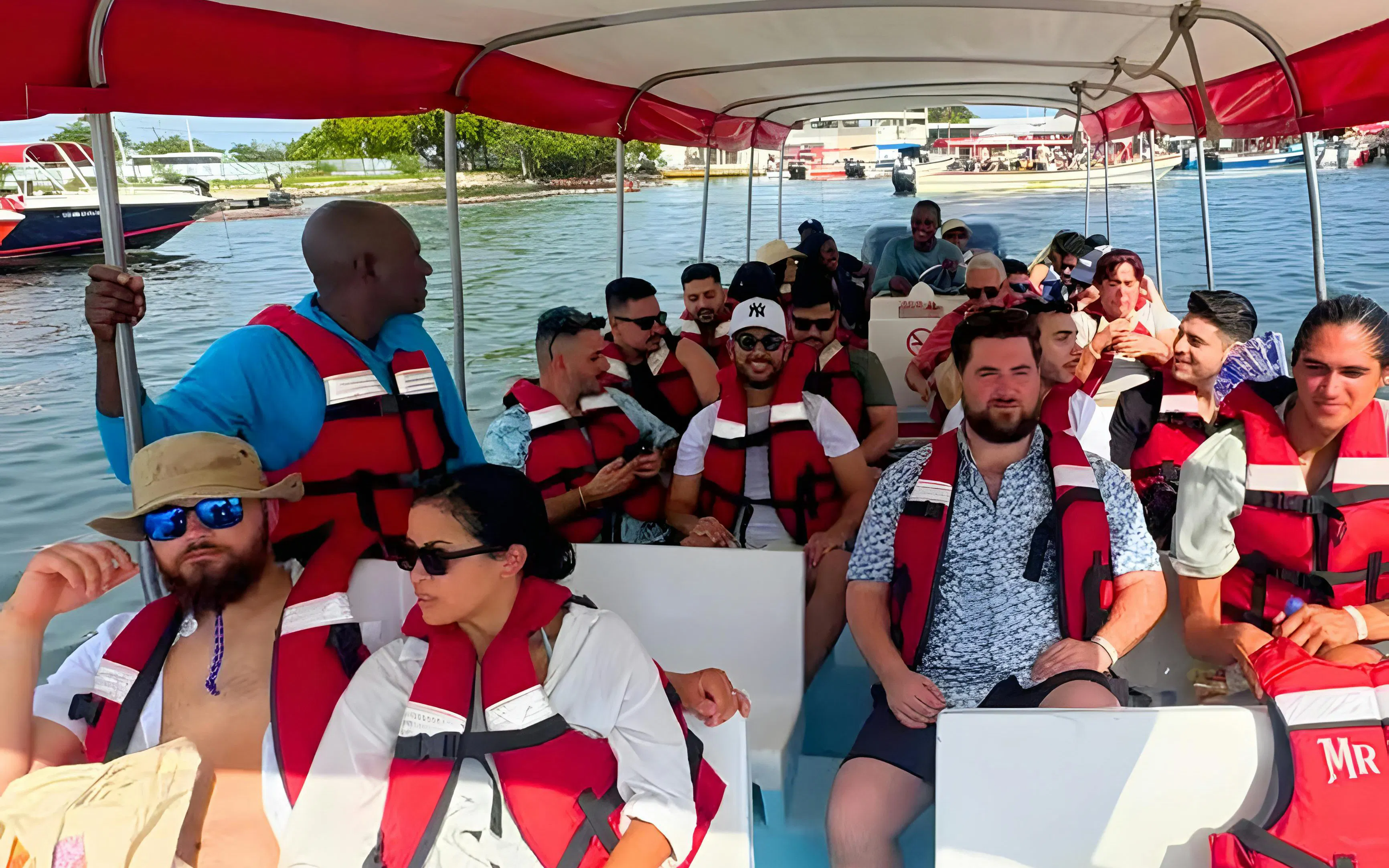 Tourists on a boat tour to Rosario Islands, Cartagena, Colombia, wearing life jackets.