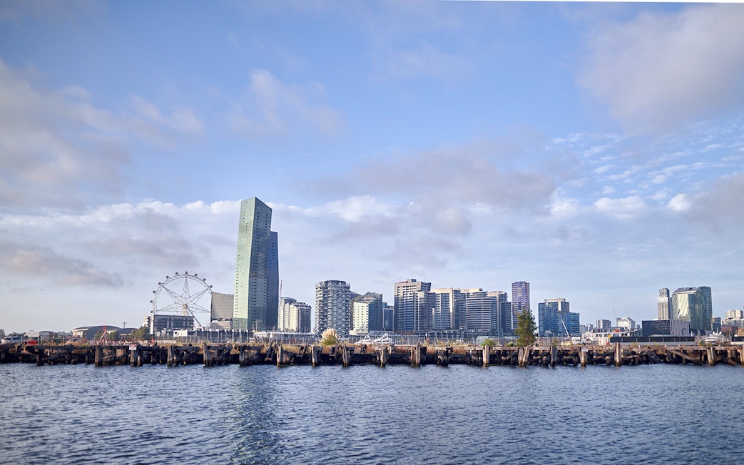 Melbourne skyline with Ferris wheel and waterfront view from Williamstown Ferry Cruise.
