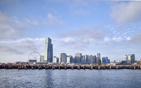 Melbourne skyline with Ferris wheel and waterfront view from Williamstown Ferry Cruise.