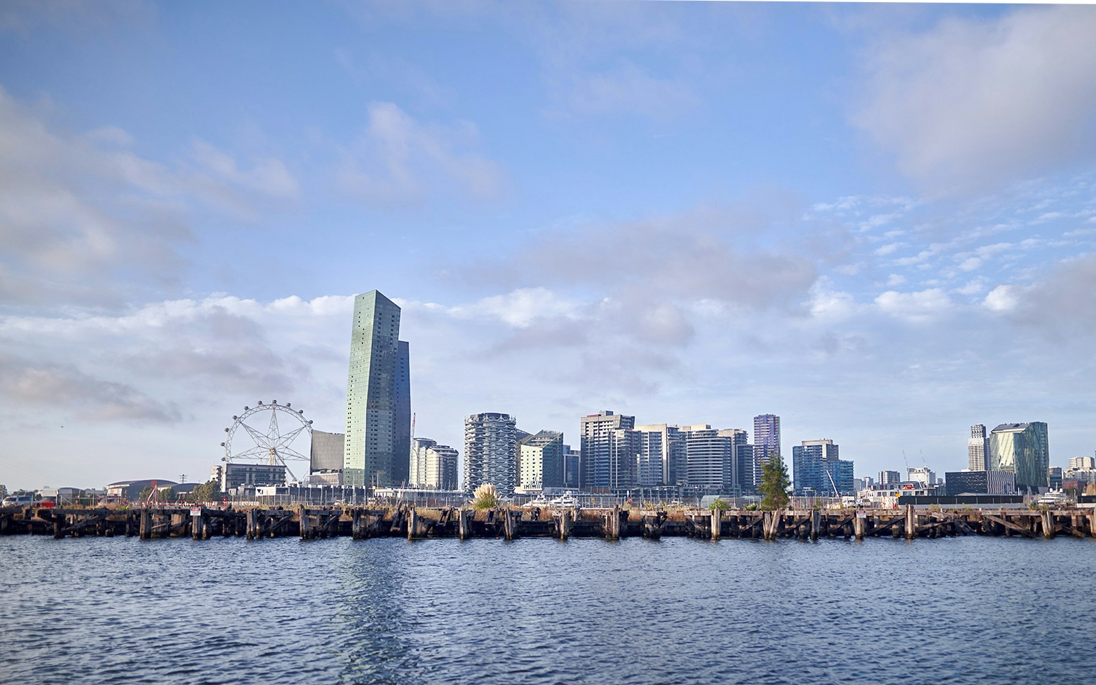 Melbourne skyline with Ferris wheel and waterfront view from Williamstown Ferry Cruise.