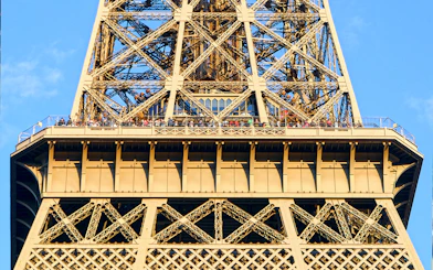 Eiffel Tower viewing platform with visitors during guided elevator tour in Paris.